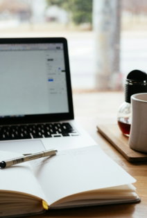 MacBook Pro near white open book